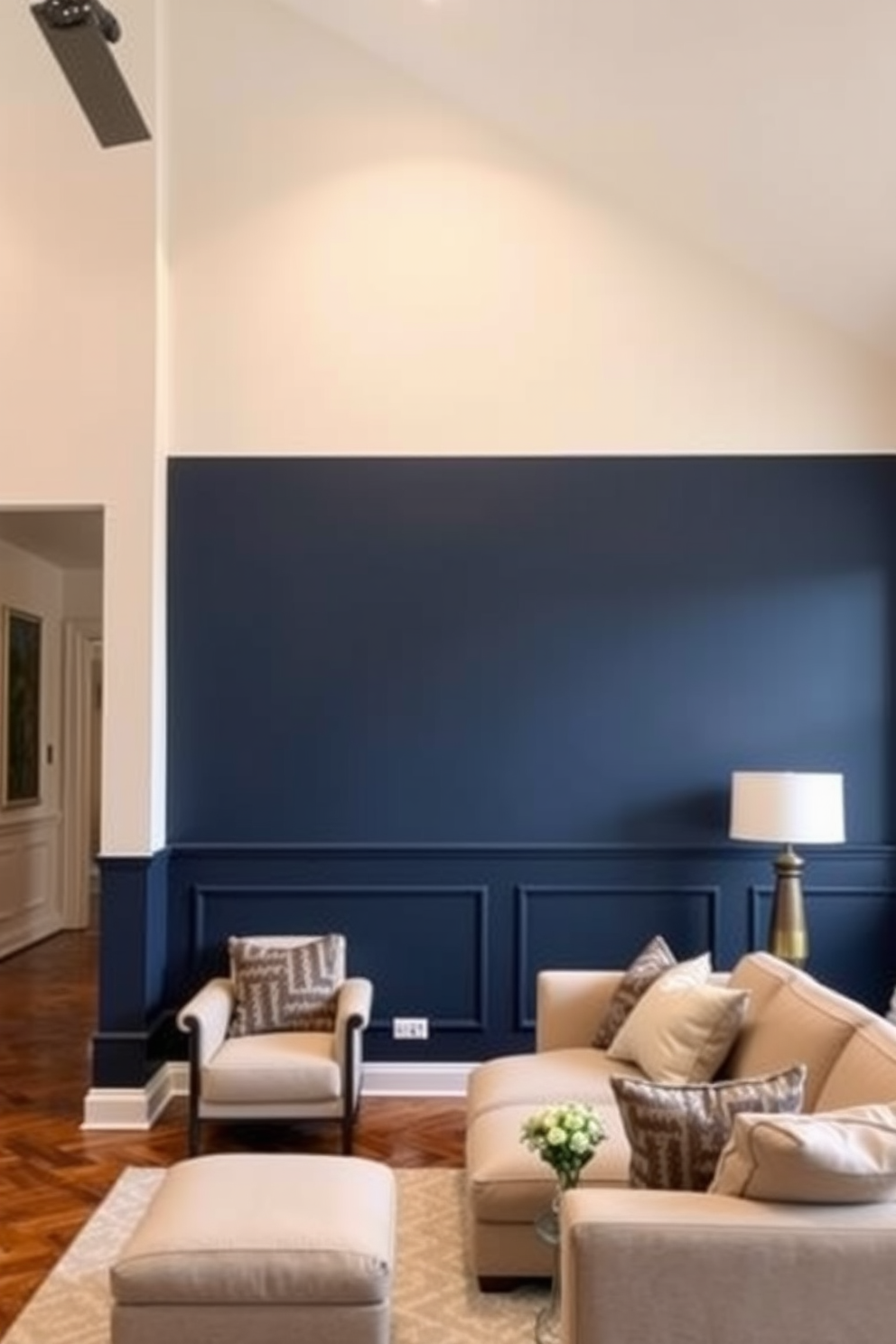 A modern living room featuring a two-tone color block design. The upper half of the walls is painted in a soft beige while the lower half is a deep navy blue, creating a striking contrast. The space is adorned with simple wall painting designs that add character without overwhelming the room. Minimalist abstract art pieces in muted tones are strategically placed to enhance the overall aesthetic.