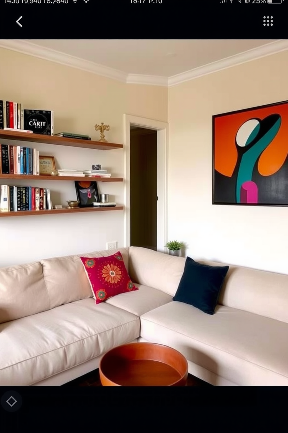 A cozy small one bedroom apartment featuring floating shelves along the living room wall for displaying books and decorative items. The color palette includes soft neutrals with pops of vibrant colors in the cushions and artwork, creating an inviting atmosphere.