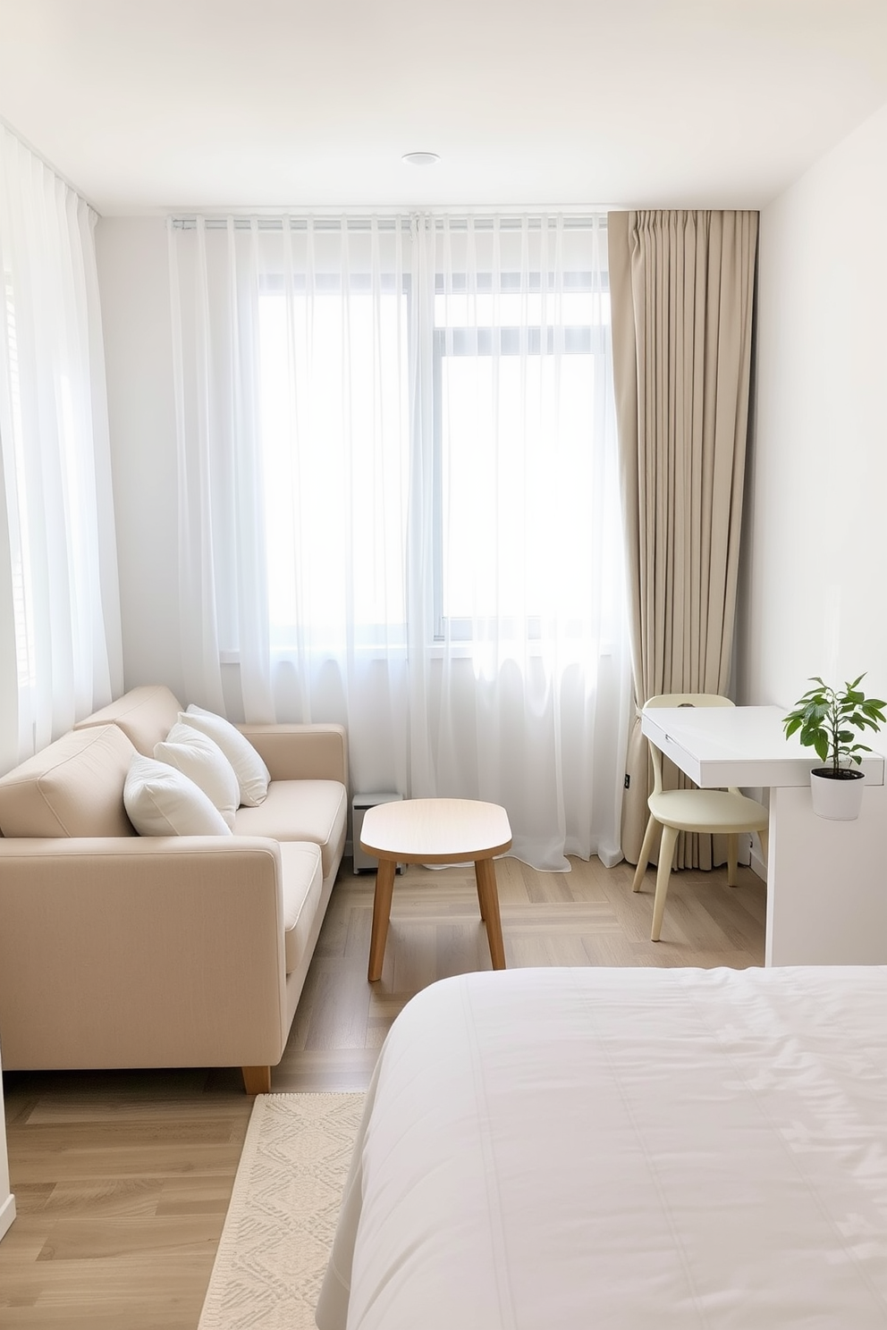 A small one bedroom apartment designed with light colors to create an airy and bright atmosphere. The living area features a soft beige sofa paired with a light wood coffee table, while sheer white curtains allow natural light to flood the room. In the bedroom, a light gray bedspread complements the pastel-colored accent pillows. A minimalist desk in the corner is adorned with a small potted plant, adding a touch of greenery to the serene space.