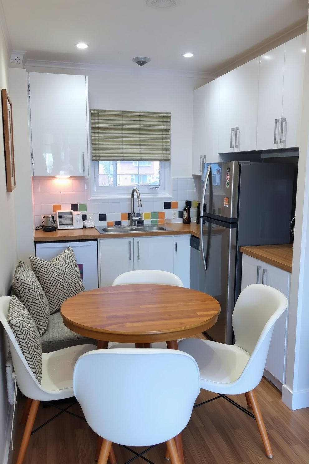 A cozy small apartment kitchen featuring a charming breakfast nook with a round wooden table surrounded by cushioned chairs. The kitchen has sleek white cabinets, a stainless steel refrigerator, and a compact stove, with colorful backsplash tiles adding a pop of personality.