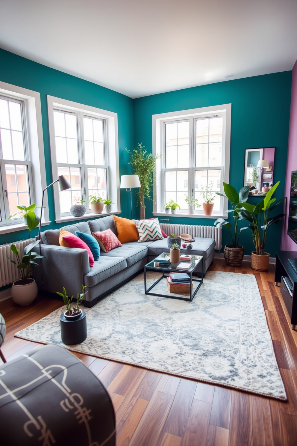 A cozy small apartment living room featuring a vibrant accent wall painted in a rich teal color. The room includes a plush gray sofa adorned with colorful throw pillows, a sleek coffee table, and a stylish area rug that ties the space together. Large windows allow natural light to flood the room, highlighting the open layout and making it feel more spacious. A few potted plants are strategically placed around the room, adding a touch of greenery and warmth to the overall design.