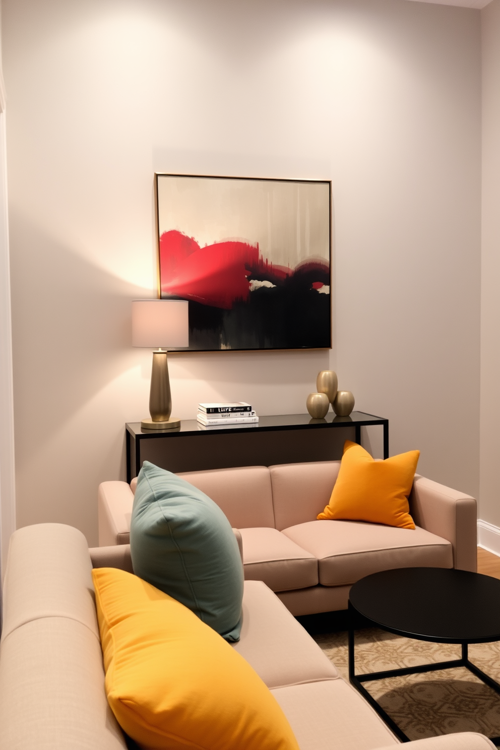 A narrow console table is positioned against the wall, adorned with a stylish lamp and a few decorative books. The wall above features a large piece of abstract art that adds a pop of color to the space. In front of the console, a cozy seating area is created with a small, plush sofa and a chic coffee table. Soft throw pillows in complementary colors enhance the inviting atmosphere of this small apartment living room.