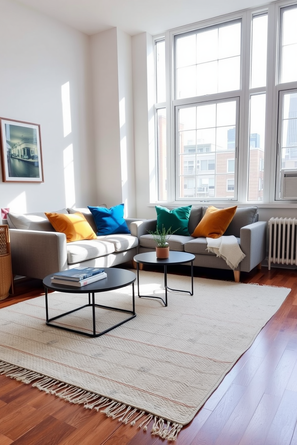 A cozy small apartment living room features a stylish sofa with exposed wooden legs in a light fabric. A round coffee table with a glass top and slender metal legs sits in front of the sofa, complemented by a vibrant area rug beneath. A compact bookshelf with open shelving displays an array of colorful books and decorative items. A floor lamp with a slim profile and a warm light illuminates the space, creating an inviting atmosphere.