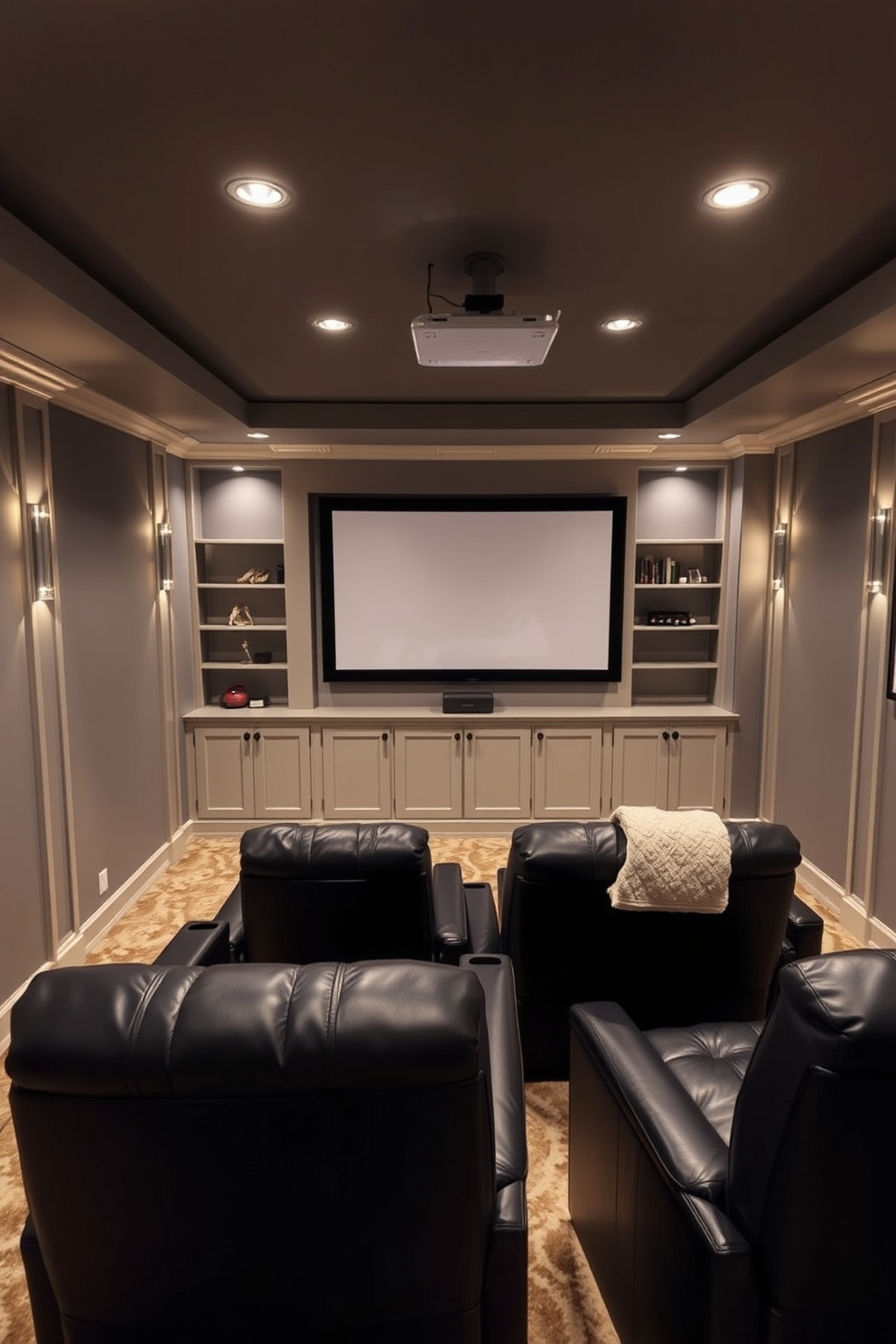 A cozy mini home theater featuring a large projector screen mounted on the wall. Plush seating arrangements with dark leather recliners face the screen, creating an inviting atmosphere. In a small basement design, the space is optimized with built-in shelving and ambient lighting. The walls are painted in a warm gray tone, and a soft area rug adds comfort underfoot.