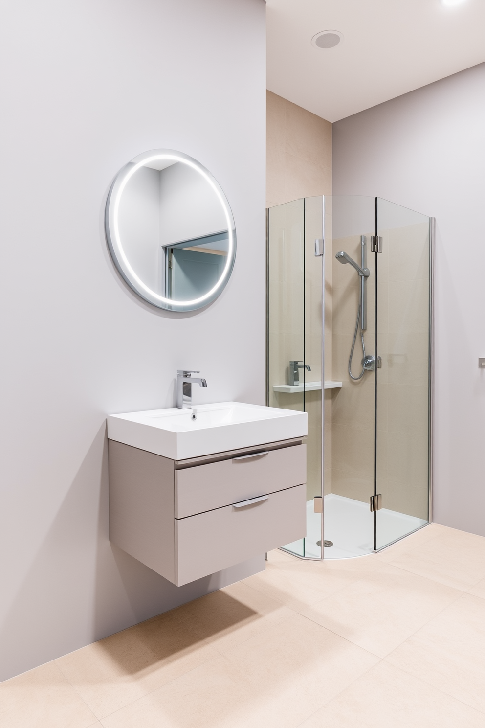 A sleek floating vanity is mounted against a light gray wall, showcasing a minimalist design with clean lines and a glossy white finish. Above the vanity, a round mirror with integrated LED lighting creates an illusion of space while enhancing the modern aesthetic. The bathroom features large format tiles in a soft beige tone, providing a warm and inviting atmosphere. A compact shower area with frameless glass doors maximizes the sense of openness, complemented by stylish fixtures in brushed nickel.