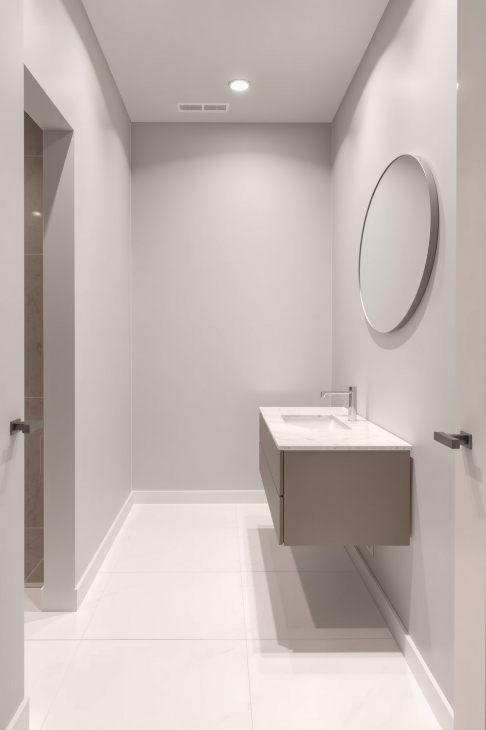 A small bathroom designed with a modern aesthetic. The walls are painted in a soft gray hue, and the floor is covered with large white tiles to create an illusion of space. A floating vanity with a quartz countertop features a single sink and minimalist hardware. Recessed lighting illuminates the space, enhancing the sleek design while a round mirror adds depth to the room.