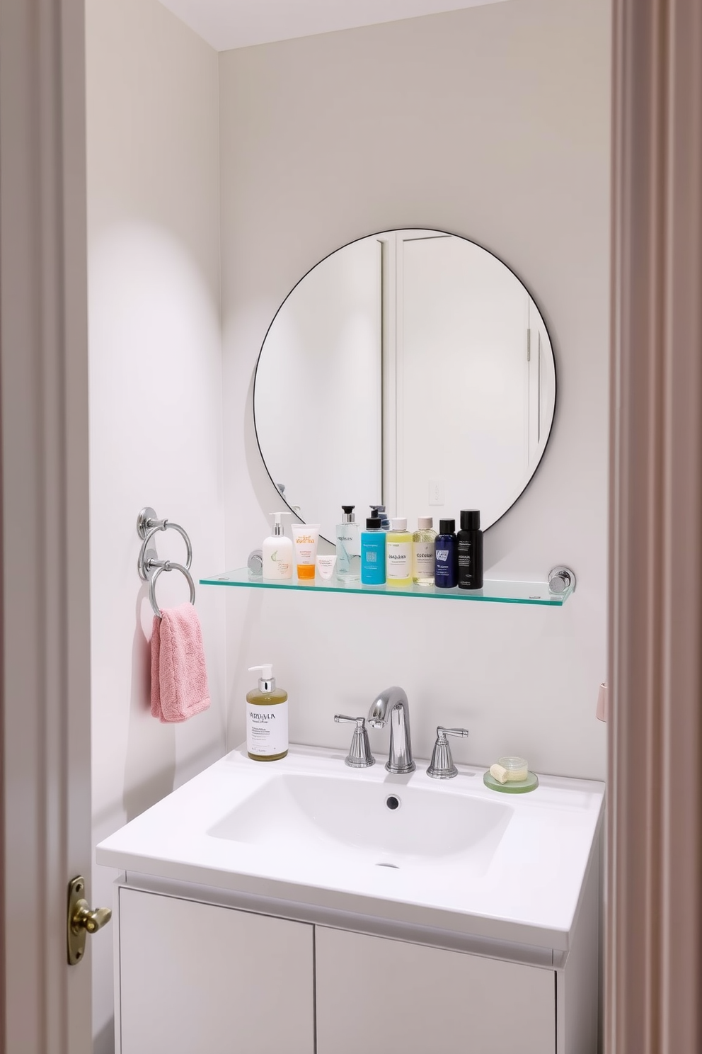 A small bathroom design featuring clear glass shower enclosures that create an open and airy feel. The walls are adorned with light gray tiles, and a compact white vanity with a sleek sink sits against one side. Natural light floods the space through a frosted window, enhancing the bright atmosphere. A minimalist shelving unit displays neatly rolled towels and decorative plants, adding a touch of greenery.