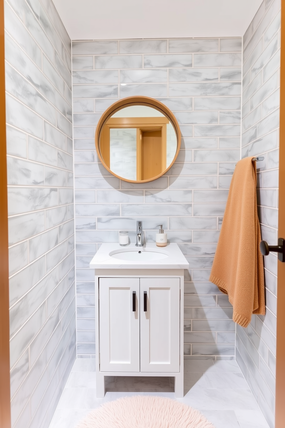 A cozy small bathroom design featuring a compact white vanity with a sleek quartz countertop. Coordinated accessories include a matching soap dispenser and toothbrush holder in soft pastel colors, enhancing the serene atmosphere. The walls are adorned with light gray tiles that create an illusion of spaciousness. A round mirror with a minimalist wooden frame hangs above the vanity, while a plush bath mat in a complementary shade adds warmth underfoot.