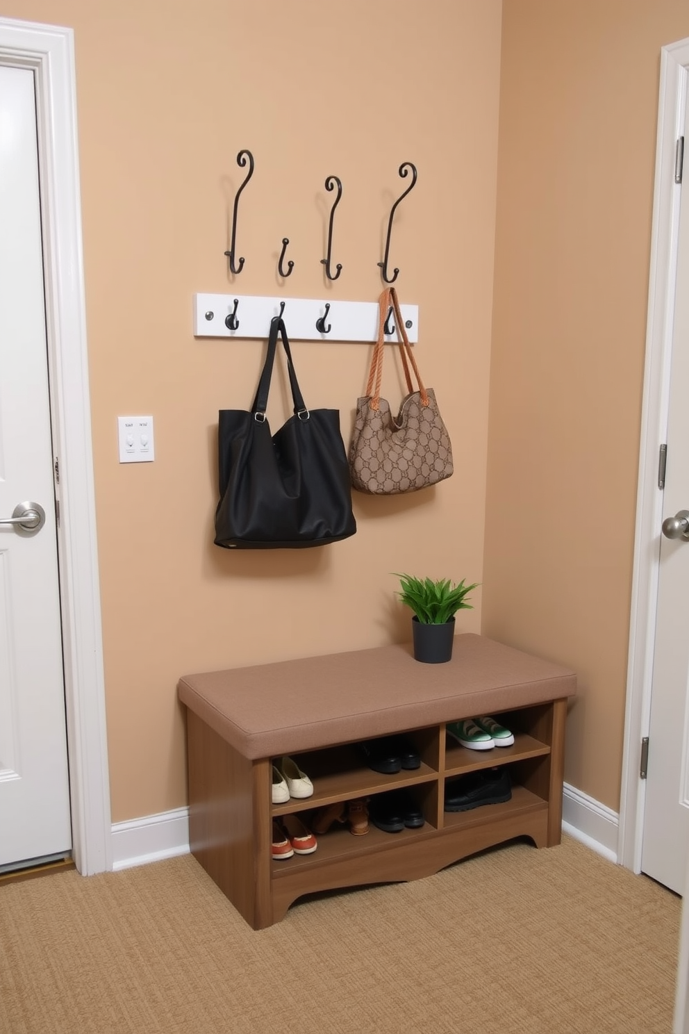 A cozy bench with shoe storage is placed against the wall in a small entryway. The bench is upholstered in a soft fabric and features a built-in compartment below for neatly storing shoes. Above the bench, a stylish wall-mounted coat rack holds several hooks for hanging jackets and bags. The walls are painted in a warm neutral tone, and a small potted plant adds a touch of greenery to the space.