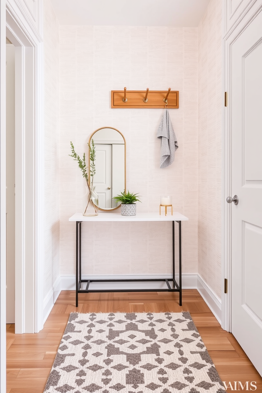 Textured wallpaper in a soft pastel hue adorns the small entryway, creating a warm and inviting atmosphere. A sleek console table with a minimalist design sits against the wall, topped with a decorative mirror and a small potted plant. The floor features a stylish patterned rug that adds a touch of elegance to the space. A wall-mounted coat rack made of natural wood provides functionality while complementing the overall aesthetic.