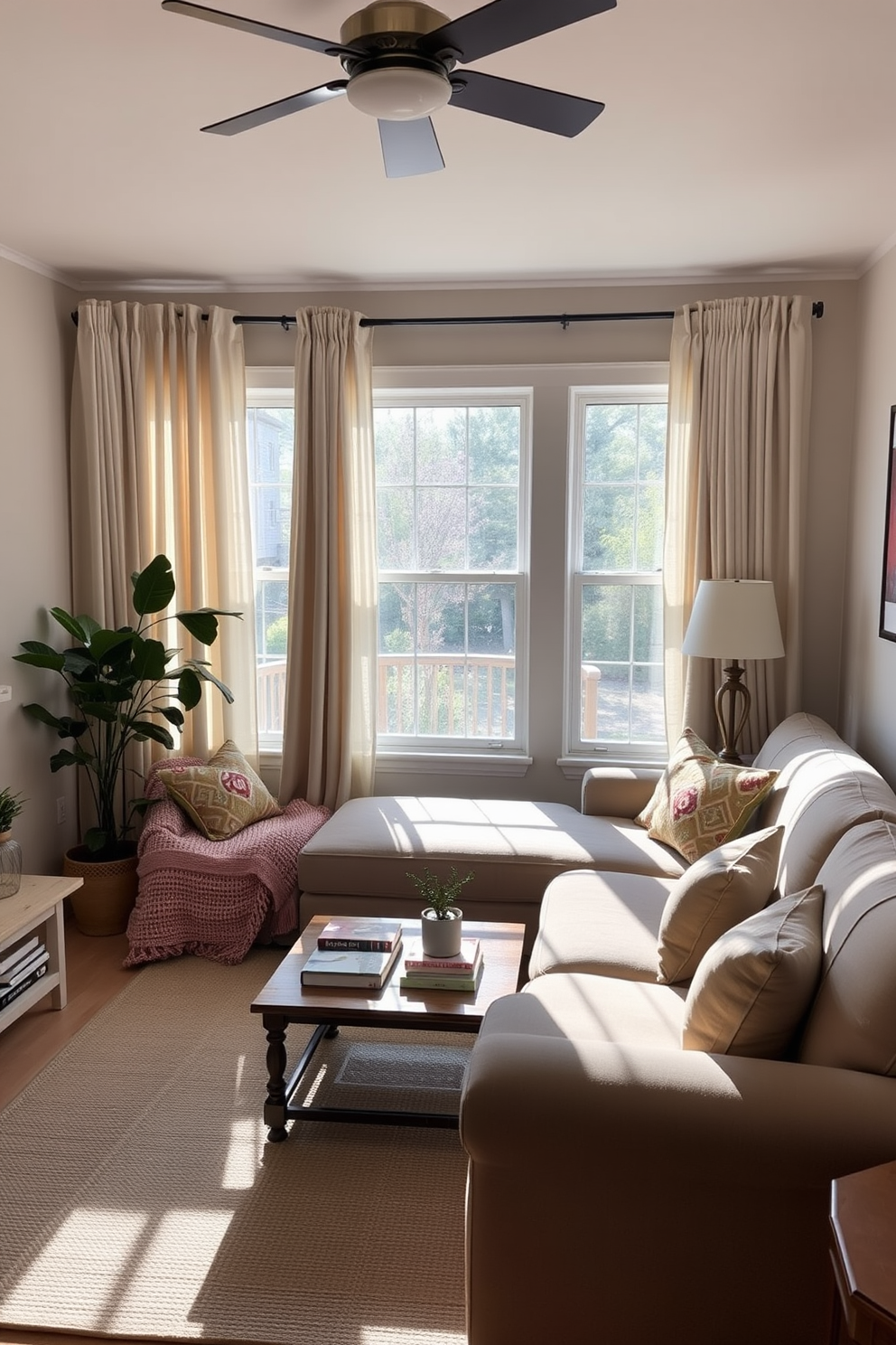 A cozy small family room filled with natural light. Soft, flowing curtains frame the windows, enhancing the inviting atmosphere. A plush sectional sofa in a neutral tone anchors the space, complemented by colorful throw pillows. A wooden coffee table sits in the center, adorned with a few decorative books and a small plant.