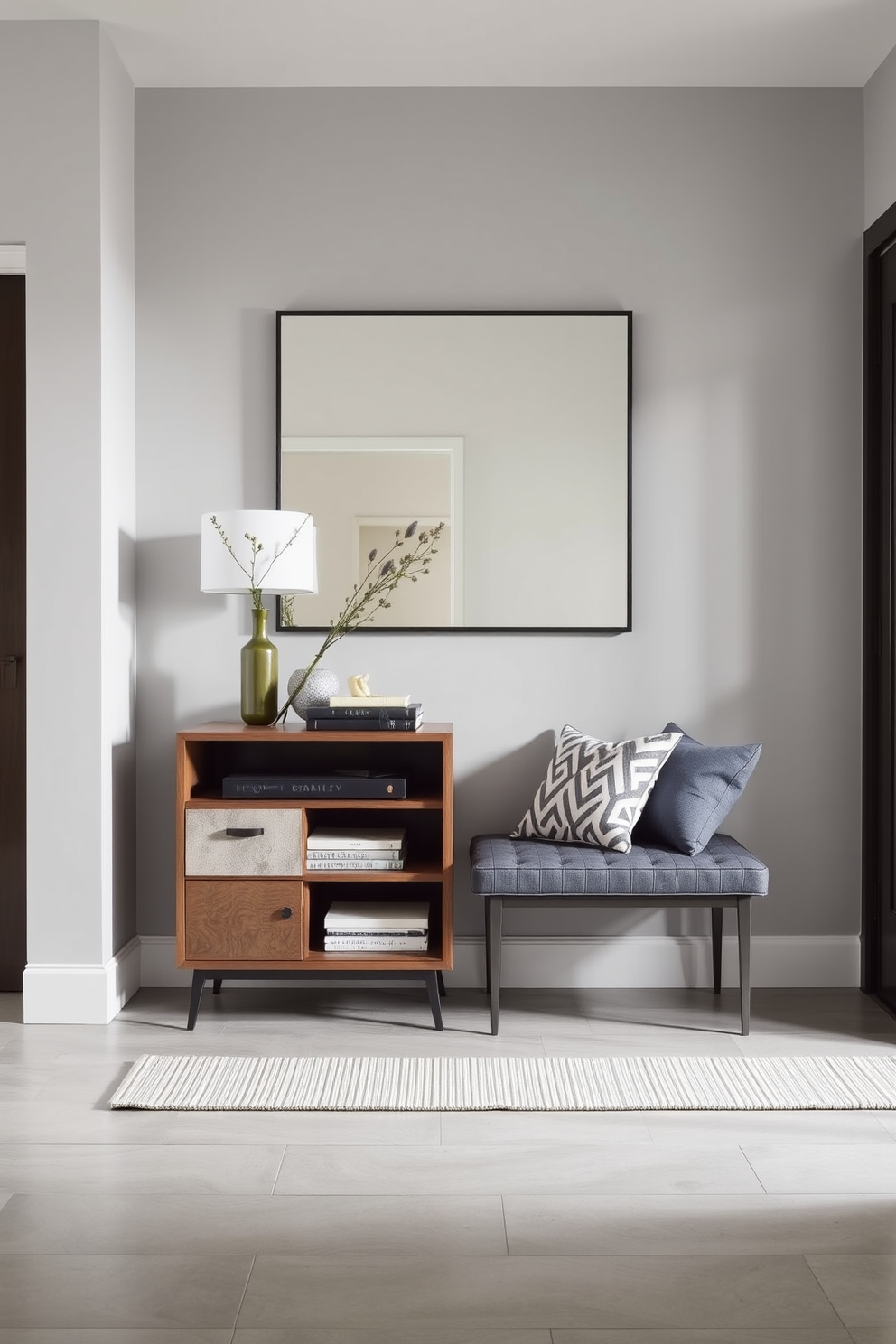 A stylish foyer featuring a sleek console table with built-in storage and a comfortable bench for seating. The walls are adorned with a soft gray paint, and a large mirror reflects natural light, creating an inviting atmosphere.