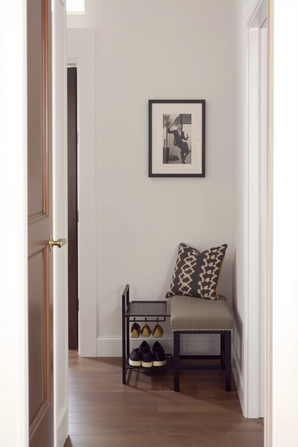 A small foyer designed to create a warm and inviting atmosphere. The walls are adorned with woven wall hangings that add texture and a cozy feel to the space. A narrow console table sits against one wall, topped with decorative items and a small plant. Soft lighting from a stylish pendant fixture illuminates the area, enhancing the welcoming ambiance.