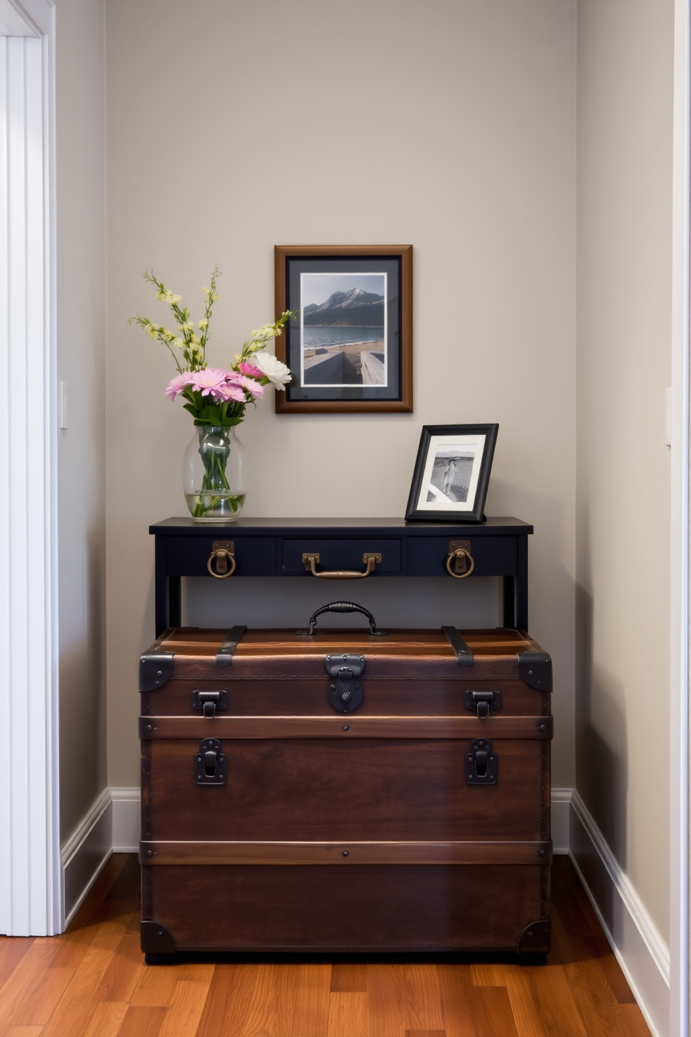 A small foyer with light-colored walls that create an airy feel. A large round mirror is mounted above a sleek console table, reflecting the natural light from a nearby window. The console table is adorned with a stylish lamp and a small potted plant. A woven basket sits on the floor, adding texture and providing a space for shoes or accessories.