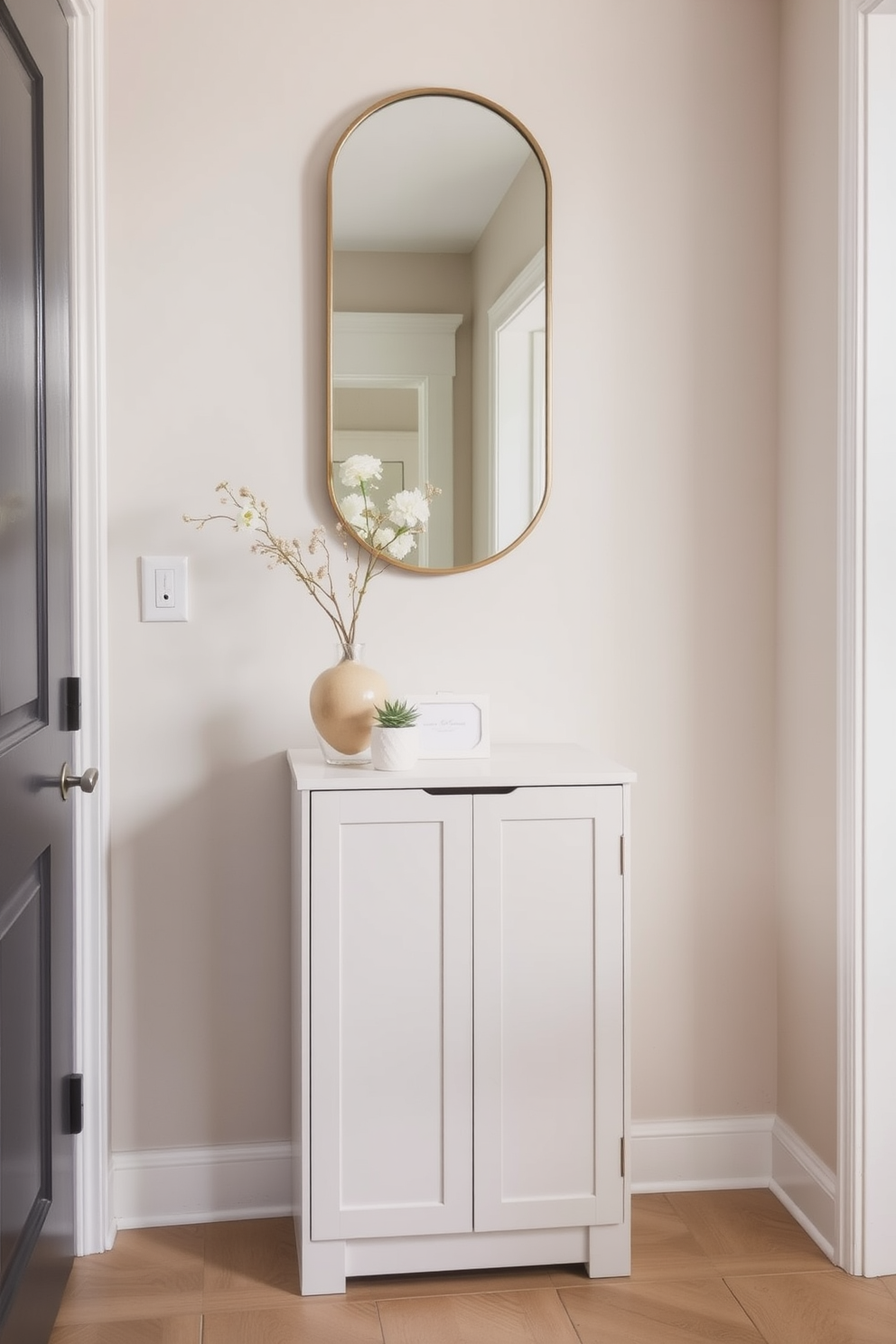 A narrow cabinet with a sleek design is placed against the wall, providing essential storage without overwhelming the space. The foyer features a soft color palette with a statement mirror above the cabinet, reflecting light and creating a welcoming atmosphere.