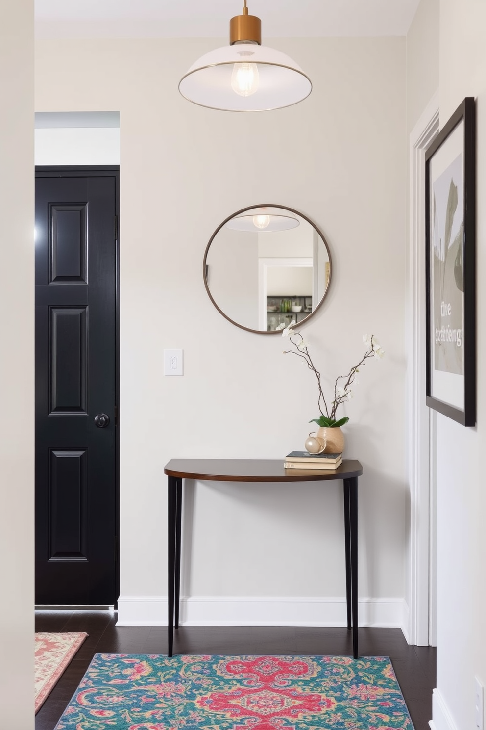 A small foyer features a stylish console table against the wall with a round mirror above it. A colorful rug adds warmth to the space, complementing the soft lighting from a modern pendant fixture overhead.