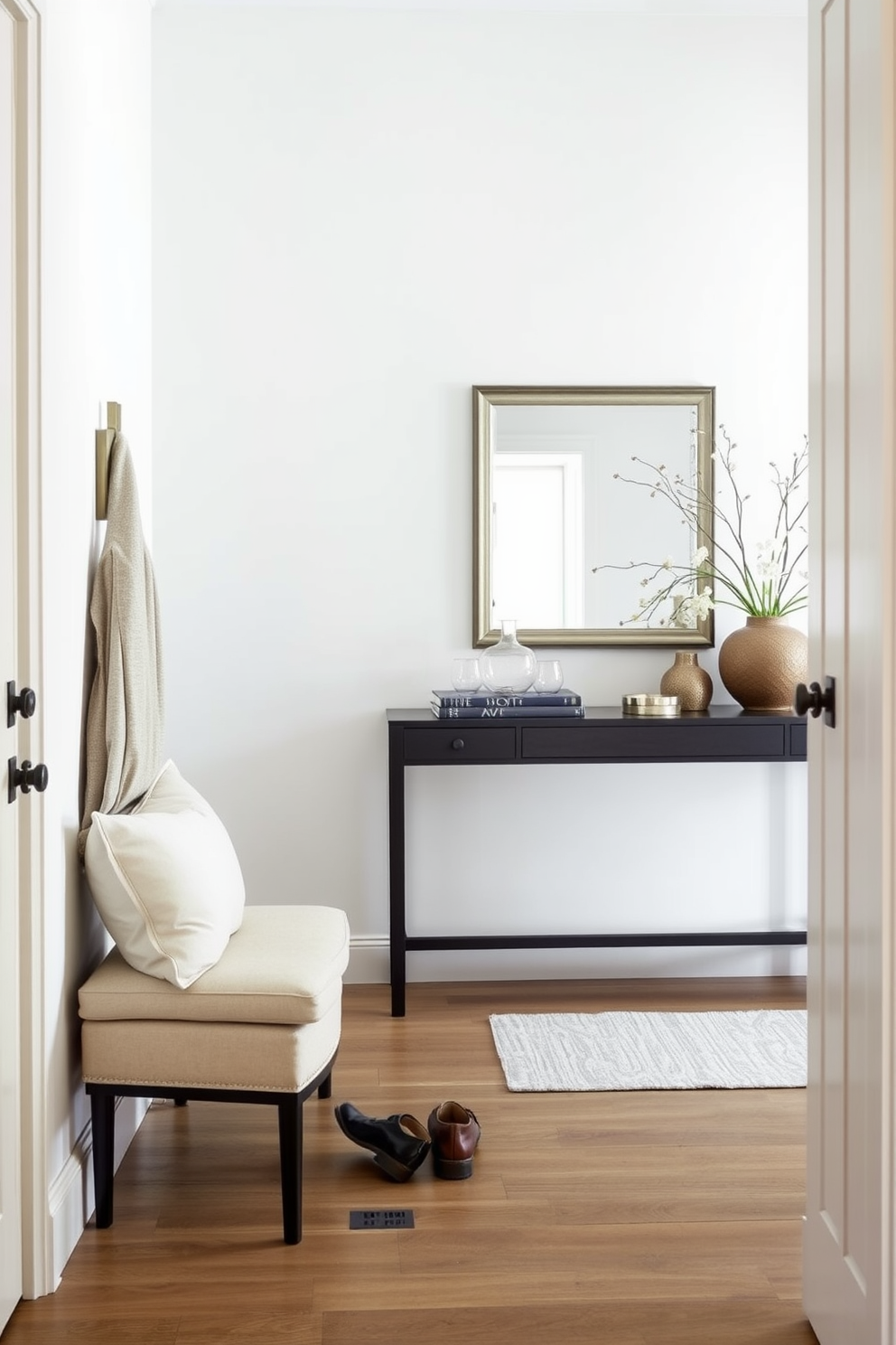 A welcoming foyer that combines functionality with style. The space features a small bench with soft cushions against the wall, providing a cozy spot for putting on shoes. The walls are painted in a light neutral tone, enhancing the airy feel of the room. A stylish console table is placed beside the bench, adorned with decorative items and a mirror above to create an inviting atmosphere.