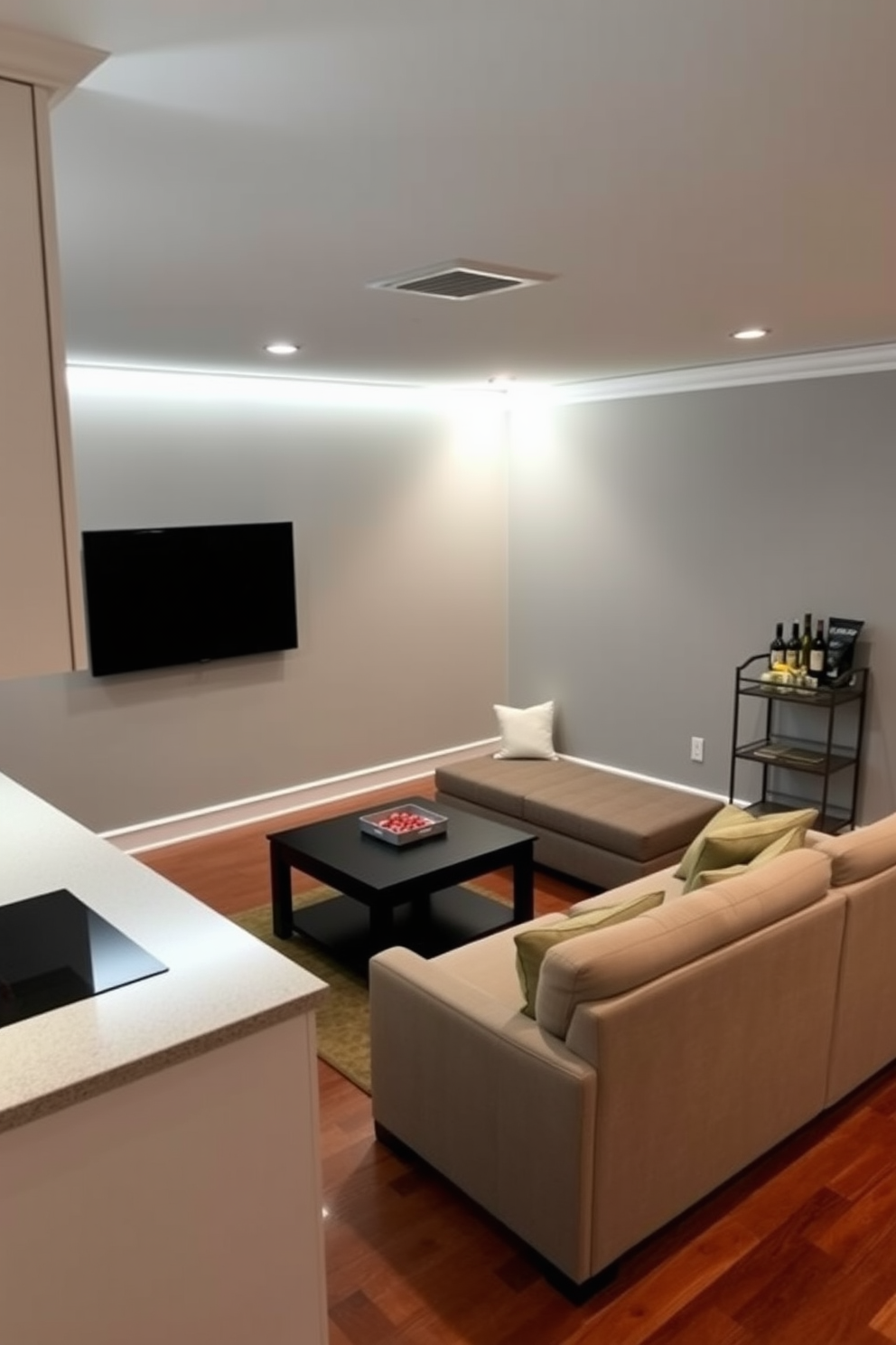 A cozy game room designed for virtual reality experiences. The room features padded walls for soundproofing and a soft carpet for comfort during gameplay. There is a large screen mounted on one wall for immersive gaming visuals. A sleek gaming console and a variety of controllers are neatly arranged on a modern entertainment unit.