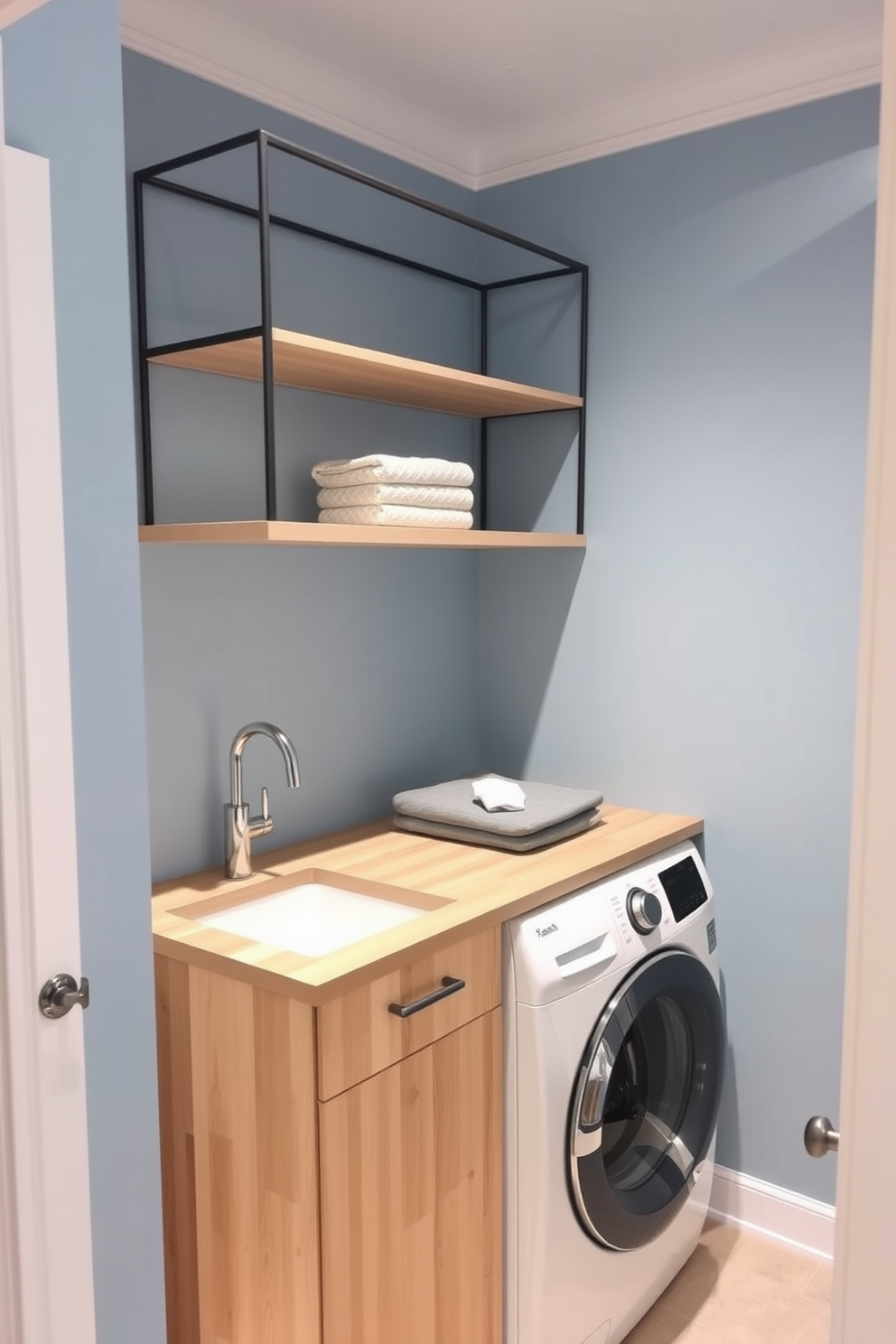 A small laundry room featuring a designated folding area with a built-in countertop made of light wood. The walls are painted in a soft blue hue, and there is a stylish shelving unit above the countertop for storage.