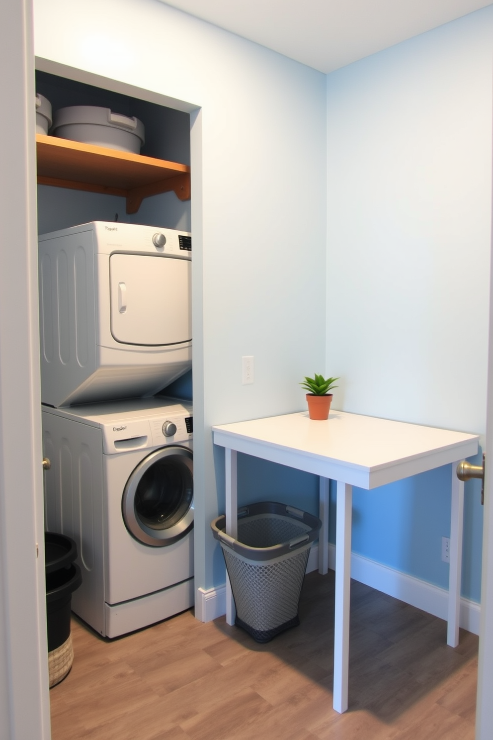 A compact laundry room featuring a folding table for convenience. The walls are painted in a light blue hue, and the floor is covered with durable vinyl tiles. On one side of the room, a stackable washer and dryer are neatly placed with storage shelves above. A laundry basket sits next to the folding table, which is adorned with a small potted plant for a touch of greenery.