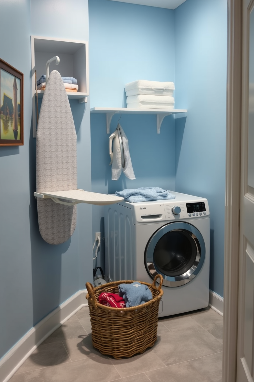 A cozy laundry room featuring a wall-mounted ironing board that folds down for convenience. The walls are painted a soft blue, and the floor is adorned with light gray tiles for a fresh look. A compact washer and dryer set is neatly tucked into a corner, with open shelving above for storage. A wicker basket sits on the floor, filled with freshly laundered clothes, adding a touch of warmth to the space.