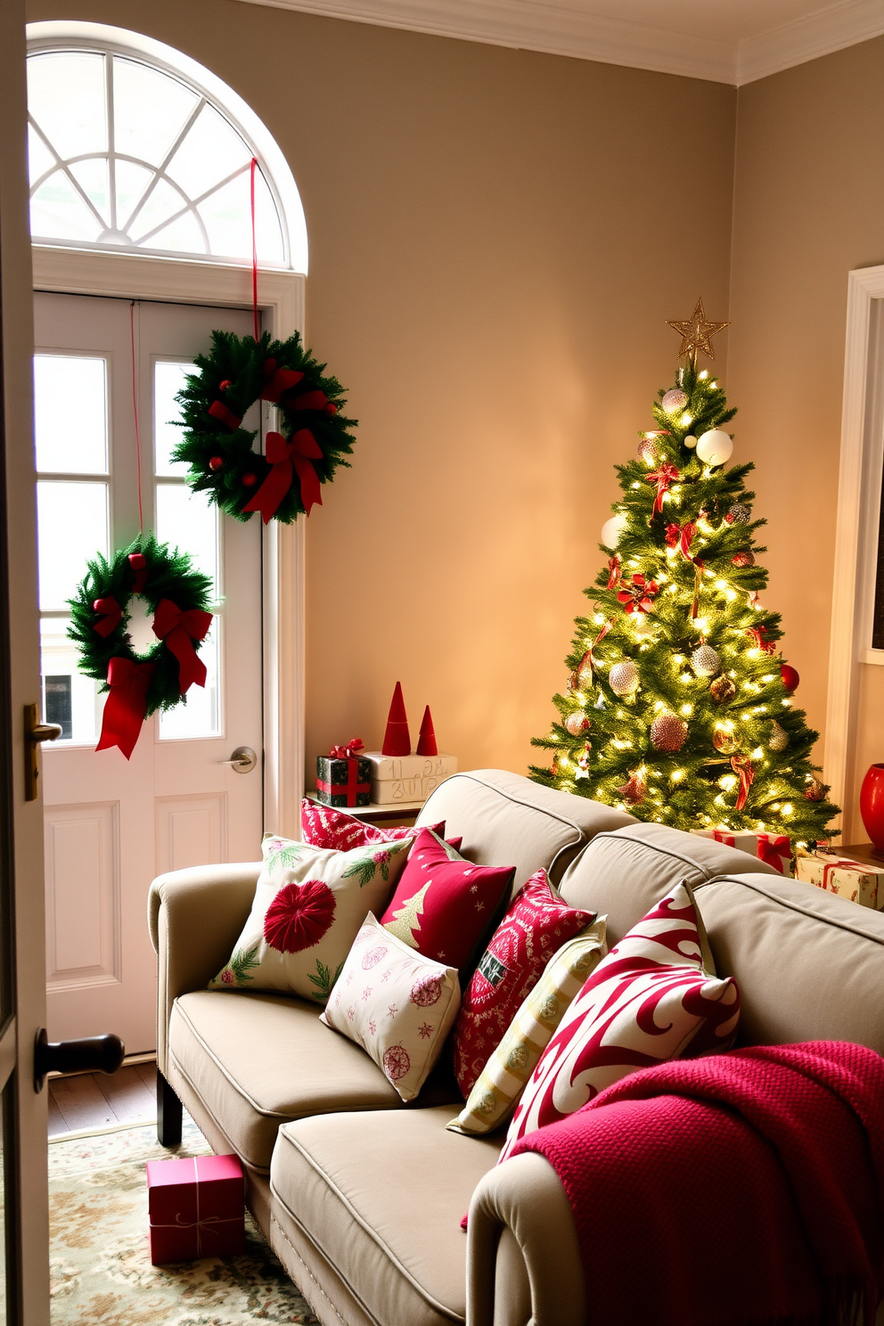 A cozy small living room decorated for Christmas. A plush green sofa is adorned with red and gold throw pillows, and a festive red and white blanket drapes over one arm. A beautifully decorated Christmas tree stands in the corner, twinkling with warm white lights and colorful ornaments. On the coffee table, a collection of scented candles in festive holders create a warm and inviting ambiance.