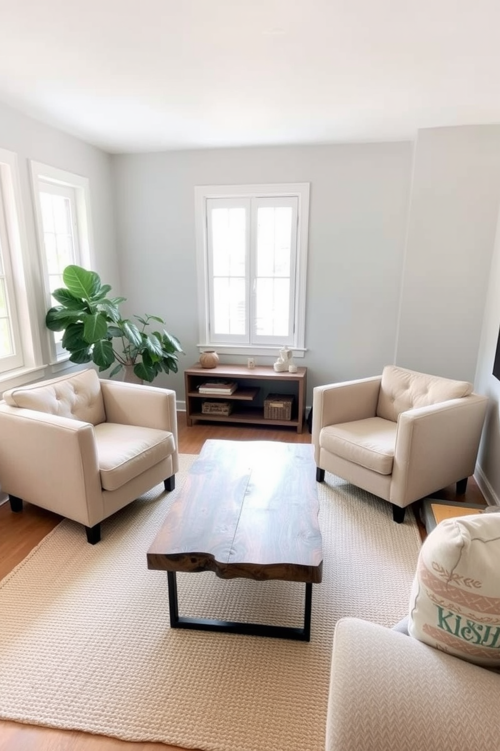 A cozy small living room filled with natural light. There are two plush armchairs in a soft beige fabric facing a modern coffee table made of reclaimed wood. In one corner, a tall leafy plant adds a touch of greenery, enhancing the fresh atmosphere. The walls are painted a light gray, and a woven rug in neutral tones anchors the seating area.