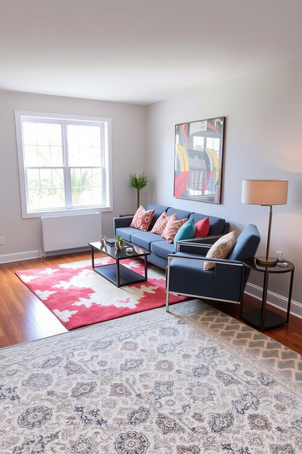 A cozy small living room featuring a large area rug that anchors the space and adds warmth. The rug is layered over hardwood flooring, complementing a comfortable sofa adorned with colorful throw pillows. In the corner, a stylish armchair invites relaxation, paired with a sleek side table holding a decorative lamp. The walls are painted in a soft neutral tone, enhancing the natural light that streams in through a large window.