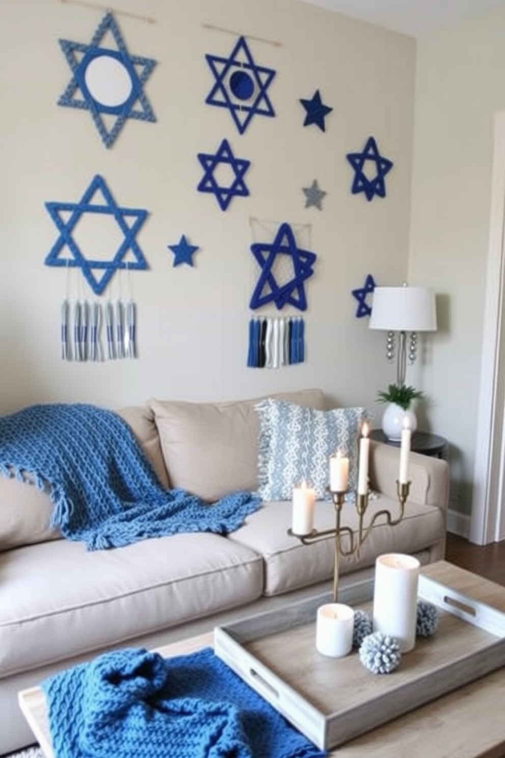 A cozy small living room adorned for Hanukkah. The walls feature DIY wall hangings made from blue and silver fabric, showcasing stars and menorahs, creating a festive atmosphere. A plush sofa is draped with a knitted throw in shades of blue. On the coffee table, a decorative tray holds candles and a small menorah, enhancing the holiday spirit.