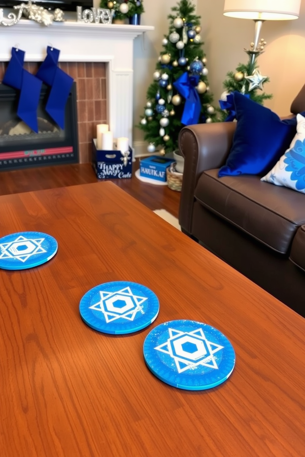 Festive coasters with Hanukkah designs are placed on a wooden coffee table in a cozy small living room. The room is adorned with blue and silver decorations, including a menorah on the mantel and a small festive tree in the corner.