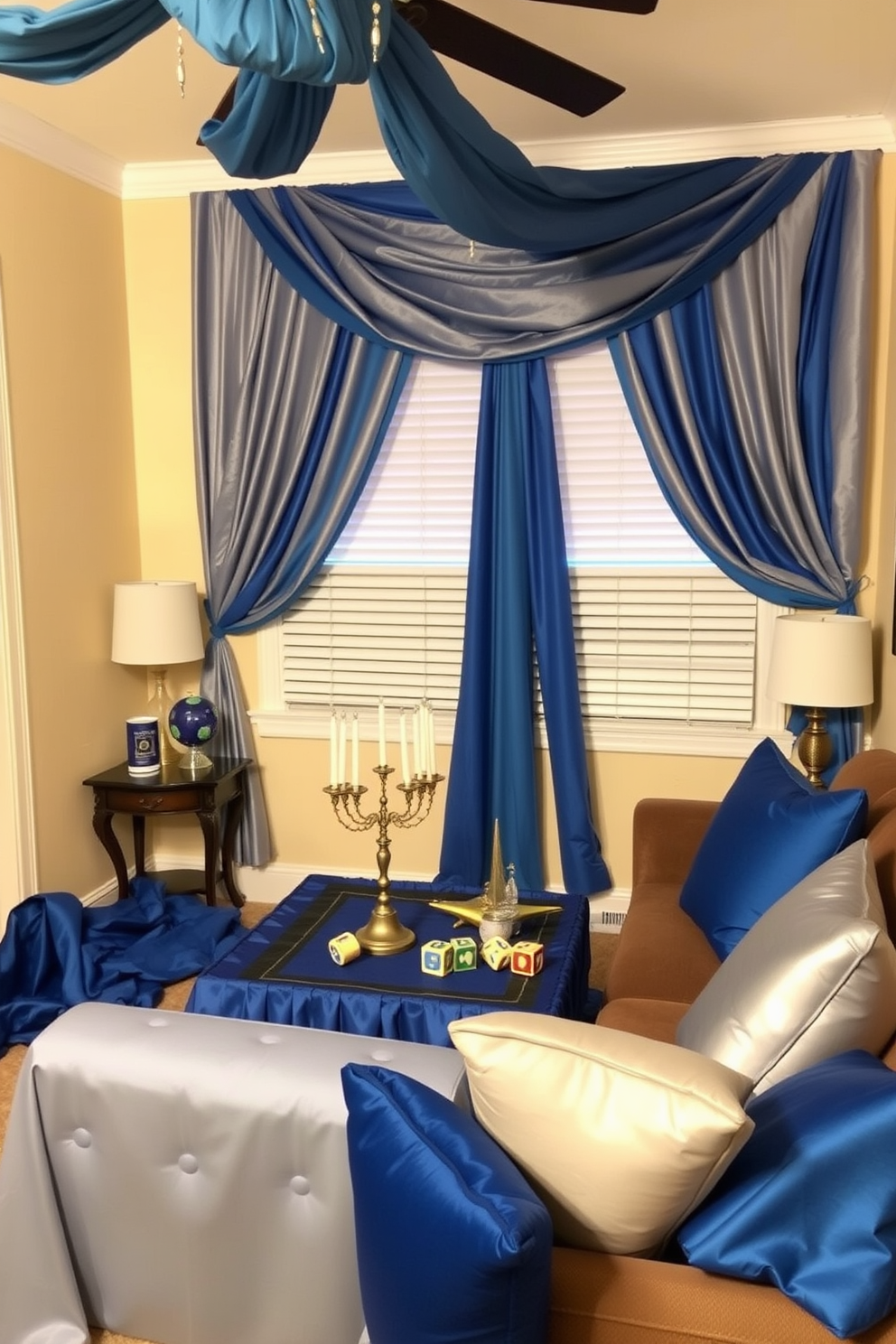 A small living room adorned for Hanukkah features creative fabric draping that adds warmth and elegance to the space. Rich blue and silver fabrics cascade from the ceiling and are artistically arranged around the windows, creating a festive atmosphere. A beautifully draped tablecloth in deep blue covers a coffee table, topped with a menorah and decorative dreidels. Soft, plush cushions in various shades of blue and silver are scattered across a cozy sofa, inviting comfort and celebration.