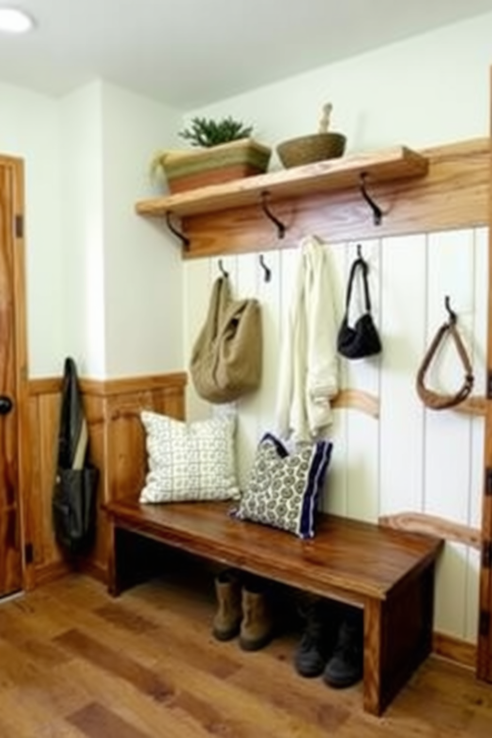 A cozy mudroom featuring rustic wood accents that add warmth and charm. The space includes a wooden bench with soft cushions, surrounded by hooks for hanging coats and bags.