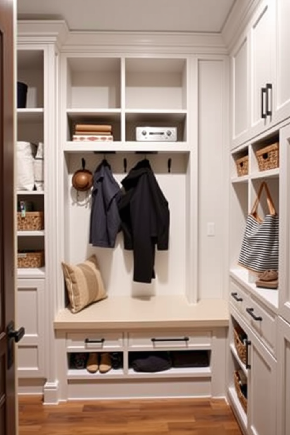 Custom cabinetry for tailored storage. The design features built-in shelves and drawers that maximize space efficiency while maintaining a sleek aesthetic. Small mudroom design ideas. The layout includes a bench for seating, hooks for coats, and a combination of open and closed storage to keep the area organized and functional.