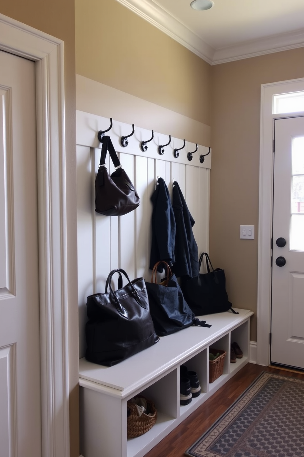 A cozy mudroom features wall hooks arranged neatly for easy access to coats and bags. The space showcases a bench with storage underneath, complemented by a warm color palette and natural light streaming in from a nearby window.