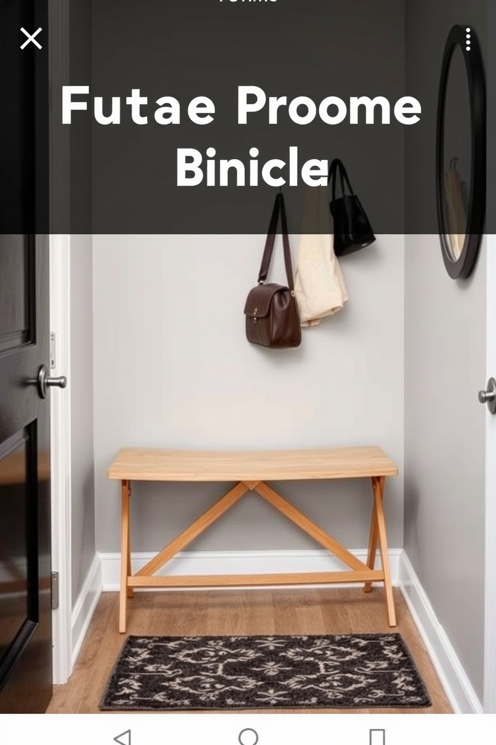 A compact folding bench is positioned against the wall in a small mudroom, offering a practical seating solution while maximizing space. The bench features a sleek design with a light wood finish, and above it, hooks are mounted for hanging coats and bags. The mudroom is painted in a soft gray hue, creating a calming atmosphere. A stylish area rug lies beneath the bench, adding warmth and texture to the entryway.