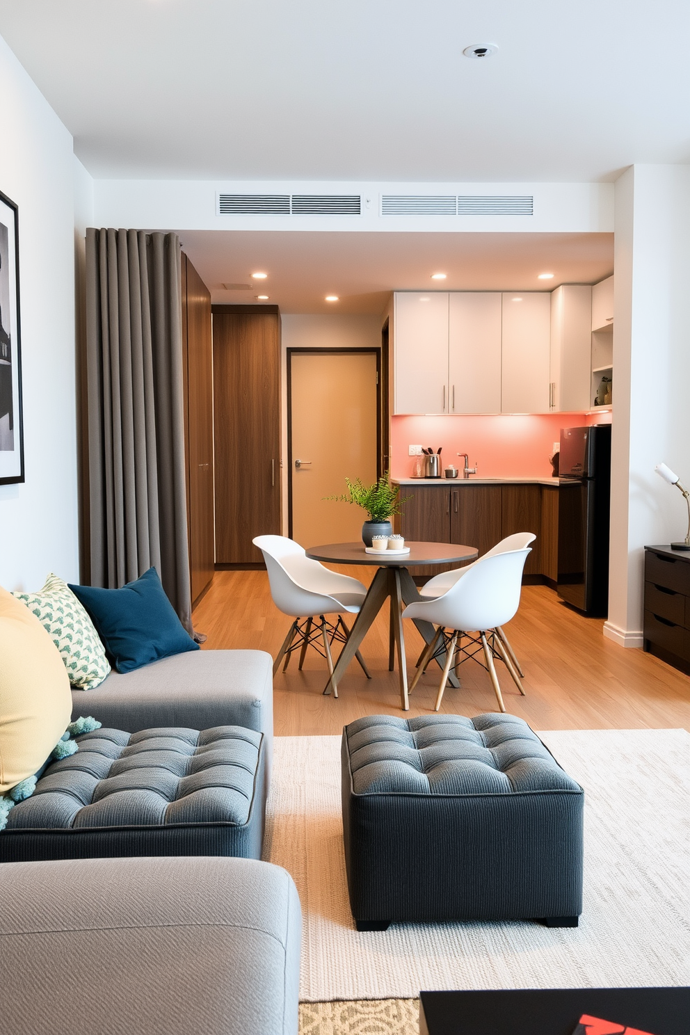 A small studio apartment featuring a wall-mounted pegboard system for organized storage. The pegboard is adorned with various hooks and shelves, displaying kitchen utensils and decorative plants.