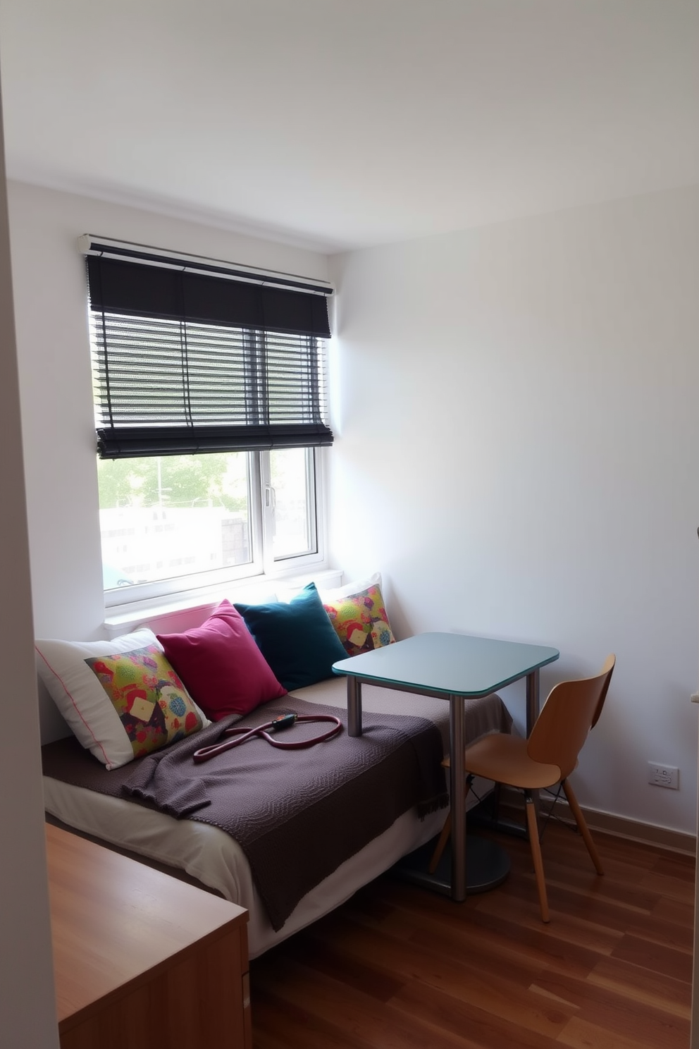 A small studio apartment design featuring a light and airy atmosphere. The walls are painted in soft white, complemented by light wood flooring that creates a seamless flow throughout the space. In the living area, a cozy sofa in a pale gray fabric faces a minimalist coffee table made of glass and metal. A small dining nook with a round table and two chairs is positioned near a window, allowing natural light to fill the room. The kitchen area features sleek white cabinets and a subtle backsplash that adds depth without overwhelming the space. Decorative plants are strategically placed to bring life and freshness to the studio, enhancing the overall aesthetic.