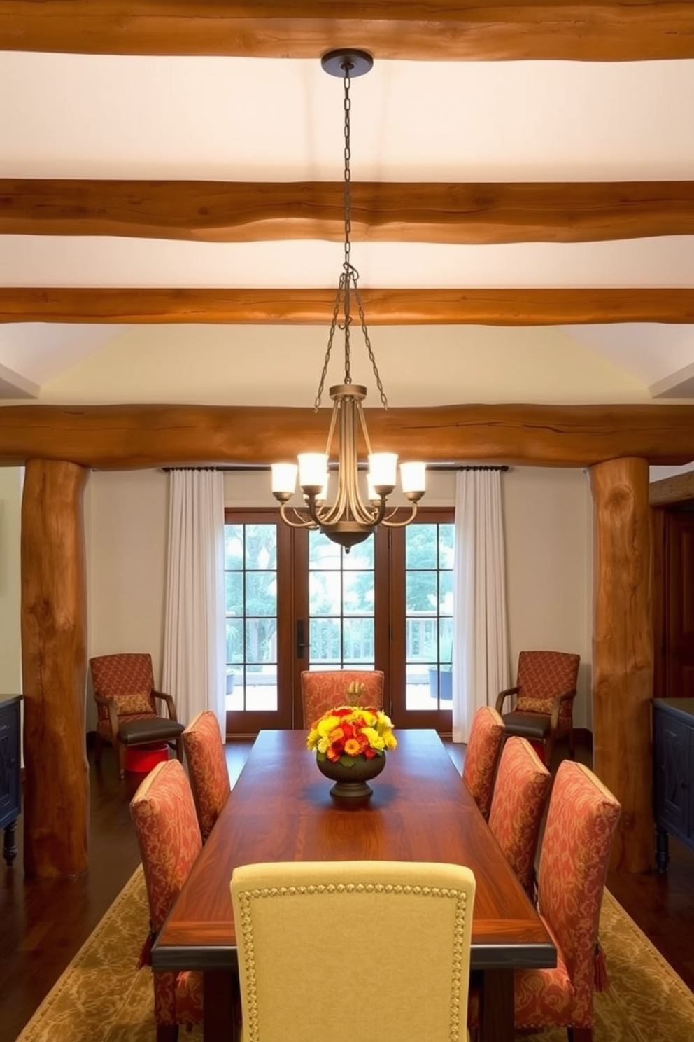 A Southwestern dining room featuring natural wood beams across the ceiling creates a warm and inviting atmosphere. The space is adorned with a large wooden dining table surrounded by colorful upholstered chairs, complemented by a rustic chandelier that adds charm.