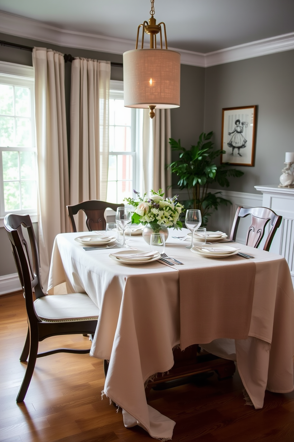 Layered textures create a warm and inviting atmosphere in the dining room. A beautifully set table features a soft linen tablecloth topped with a contrasting cotton runner, enhancing the overall aesthetic.