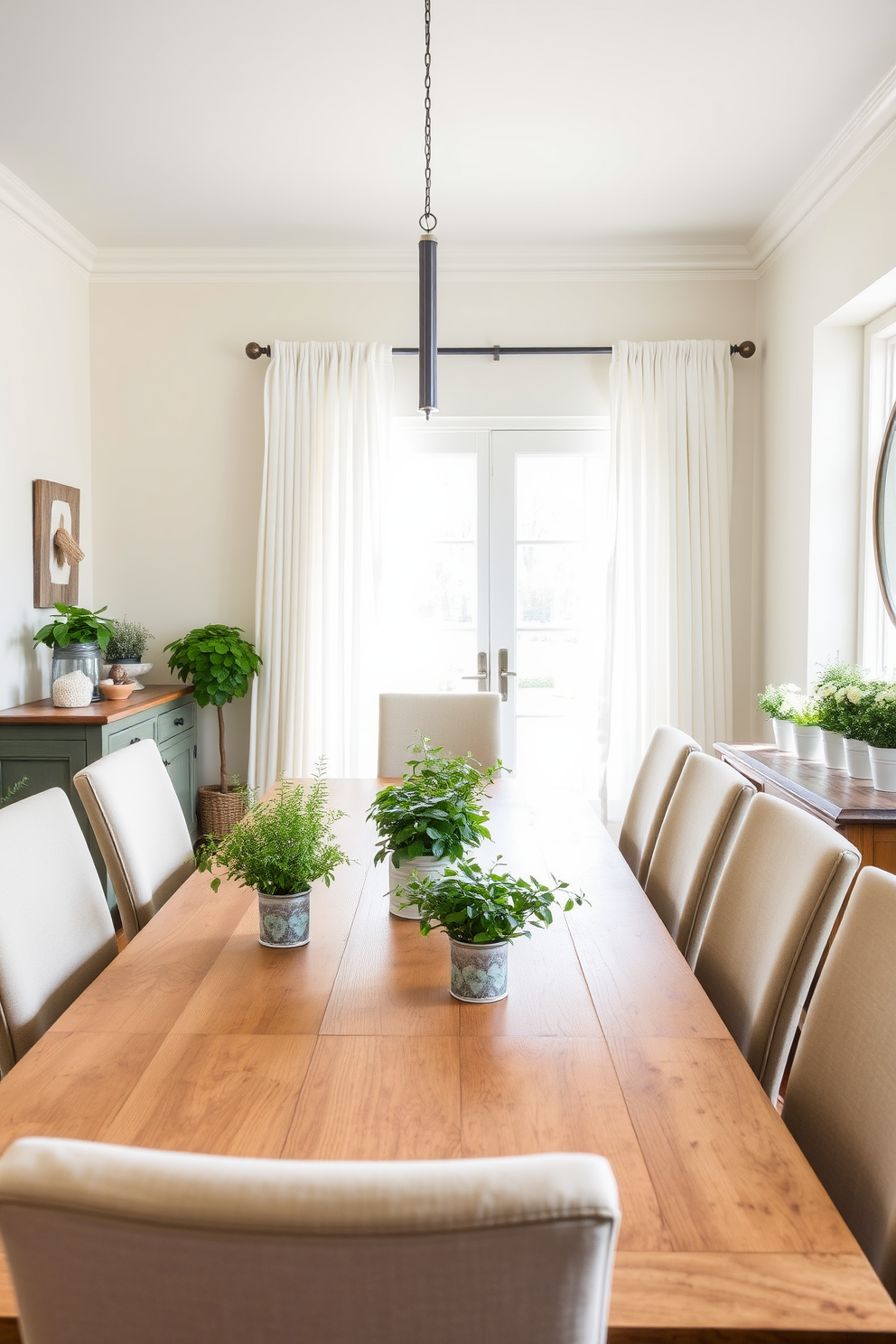 A bright and airy dining room features a large wooden table surrounded by upholstered chairs. Potted herbs in decorative containers are placed at the center of the table, adding a touch of greenery and a functional element to the decor. The walls are painted in a soft pastel hue, complemented by light, sheer curtains that allow natural light to flood the space. A rustic sideboard against one wall displays additional potted herbs, creating a cohesive and inviting atmosphere perfect for spring dining.