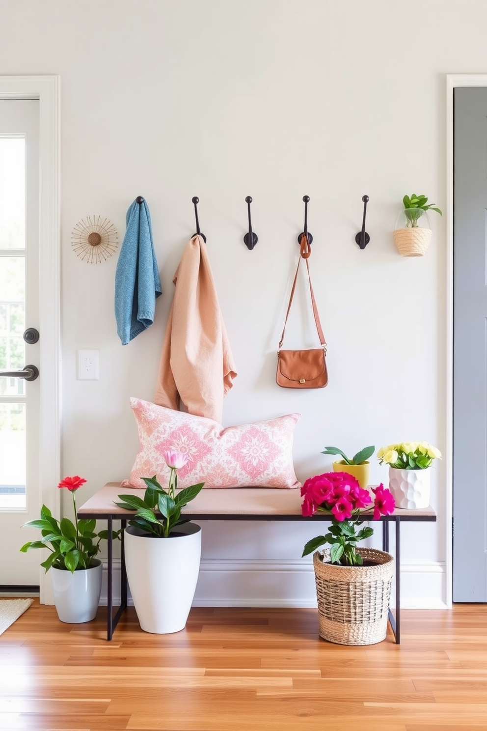 Create a stylish entryway featuring functional coat hooks that blend seamlessly with the decor. The hooks should be arranged in an artistic pattern on a light-colored wall, complemented by a chic bench and vibrant potted plants nearby. Incorporate seasonal elements to enhance the spring theme, such as pastel-colored accessories and fresh flowers. The flooring should be a warm wood tone, creating a welcoming atmosphere that invites guests into the space.