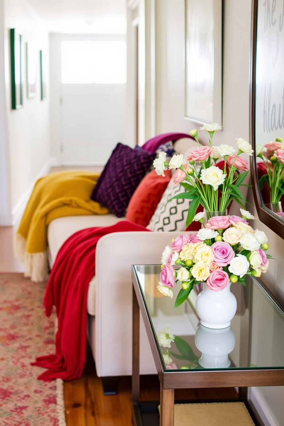 Vibrant throw blankets in rich colors are draped over a plush sofa, adding warmth and texture to the space. The sofa is complemented by a collection of decorative pillows in various patterns, creating an inviting atmosphere. In the spring hallway, fresh blooms in pastel hues are arranged in a stylish vase on a console table. The walls are adorned with light, airy artwork that reflects the season, enhancing the cheerful ambiance of the corridor.