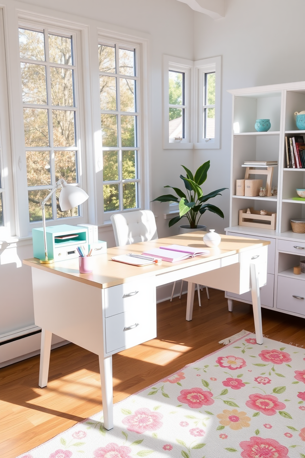 A bright and airy home office featuring pastel colored accessories. The desk is adorned with a mint green organizer, a soft pink notebook, and a lavender pen holder. Natural light floods the space through large windows, illuminating the light wooden desk and white shelving units. A cheerful floral print rug adds a touch of warmth to the room, complementing the pastel theme.