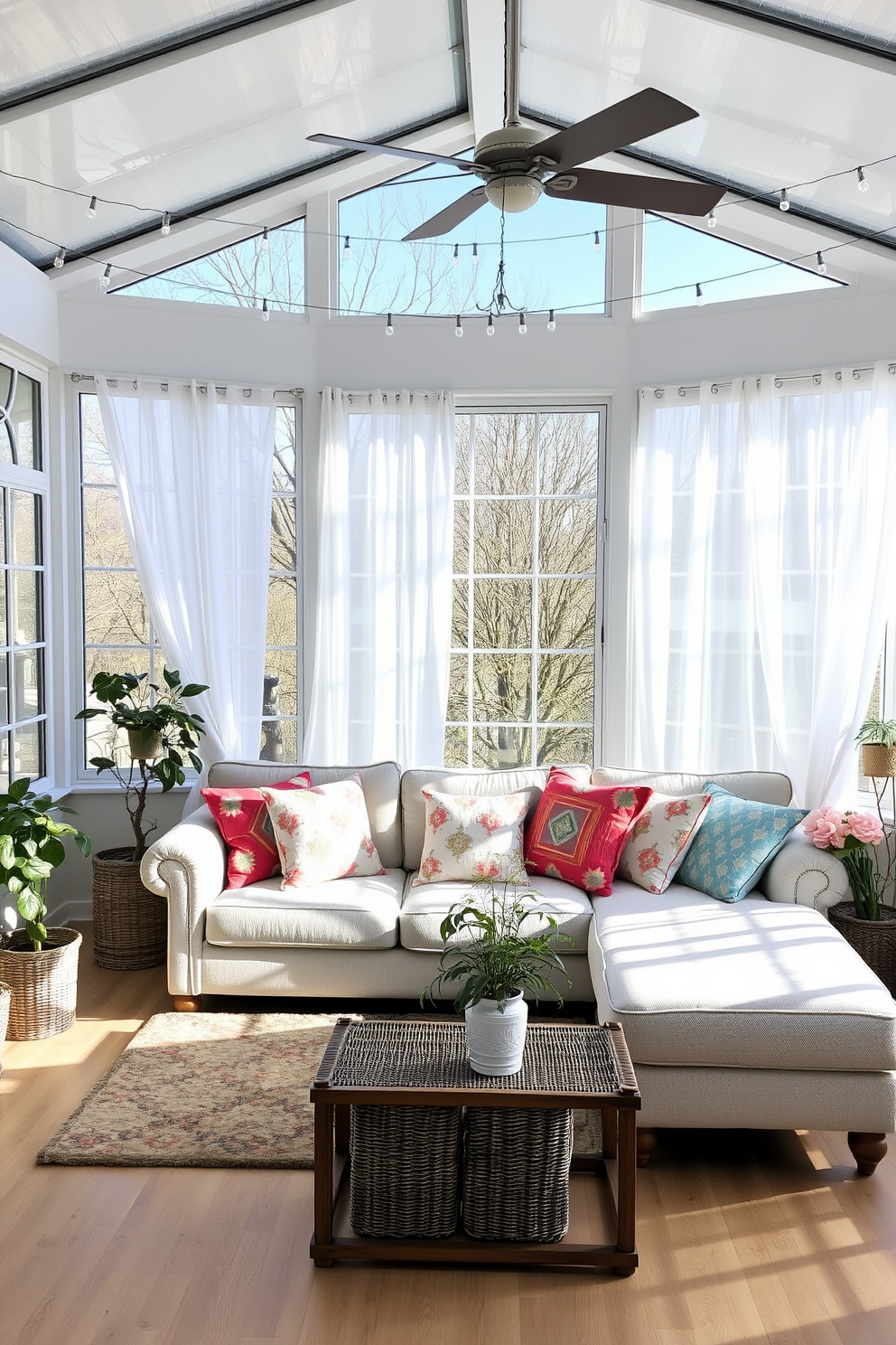 A bright and airy sunroom filled with natural light. The space features wicker furniture with soft cushions, creating a cozy and inviting atmosphere. Lush green plants are placed throughout the room, adding a touch of nature. Sheer white curtains flutter gently in the breeze, enhancing the room's freshness.