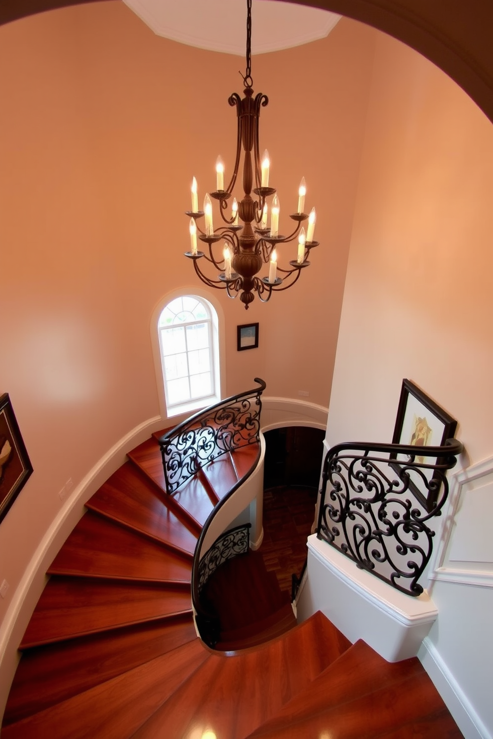 An elegant spiral staircase gracefully ascends with a stunning chandelier suspended above, casting a warm glow on the polished wooden steps. The intricate iron railing complements the sophisticated design, while the surrounding walls are adorned with tasteful artwork, enhancing the overall ambiance.