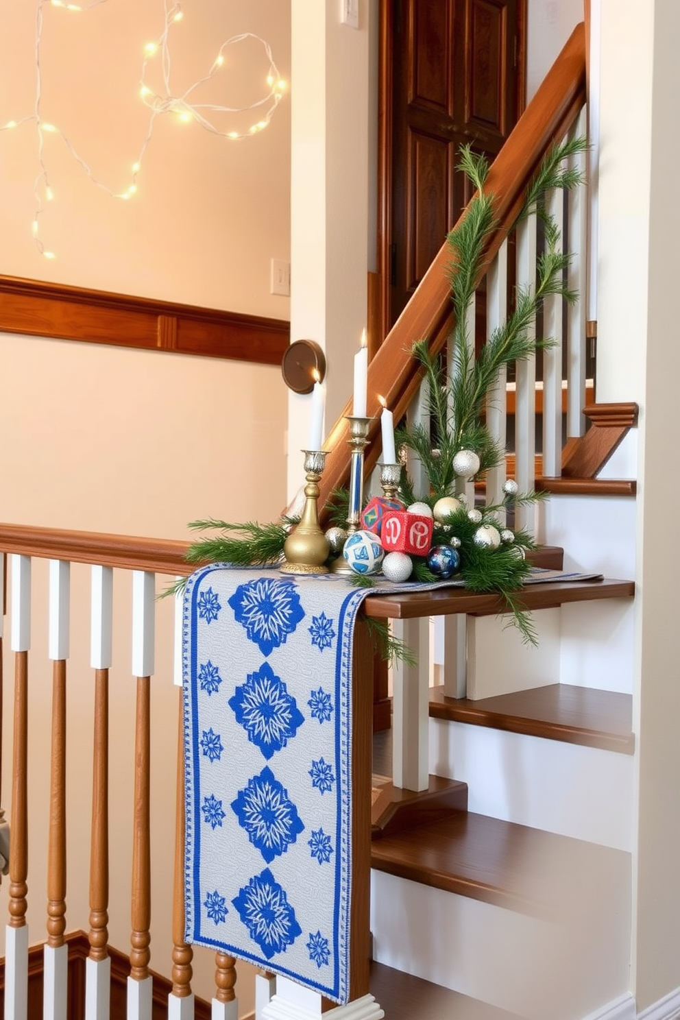 A festive table runner drapes elegantly over the polished wooden railing of the staircase landing. The runner is adorned with blue and silver patterns, complementing the warm glow of string lights that twinkle above. Decorative menorahs and vibrant dreidels are artfully arranged on the table, creating a cheerful Hanukkah display. Sprigs of evergreen and shimmering ornaments add a touch of holiday spirit to the staircase decor.