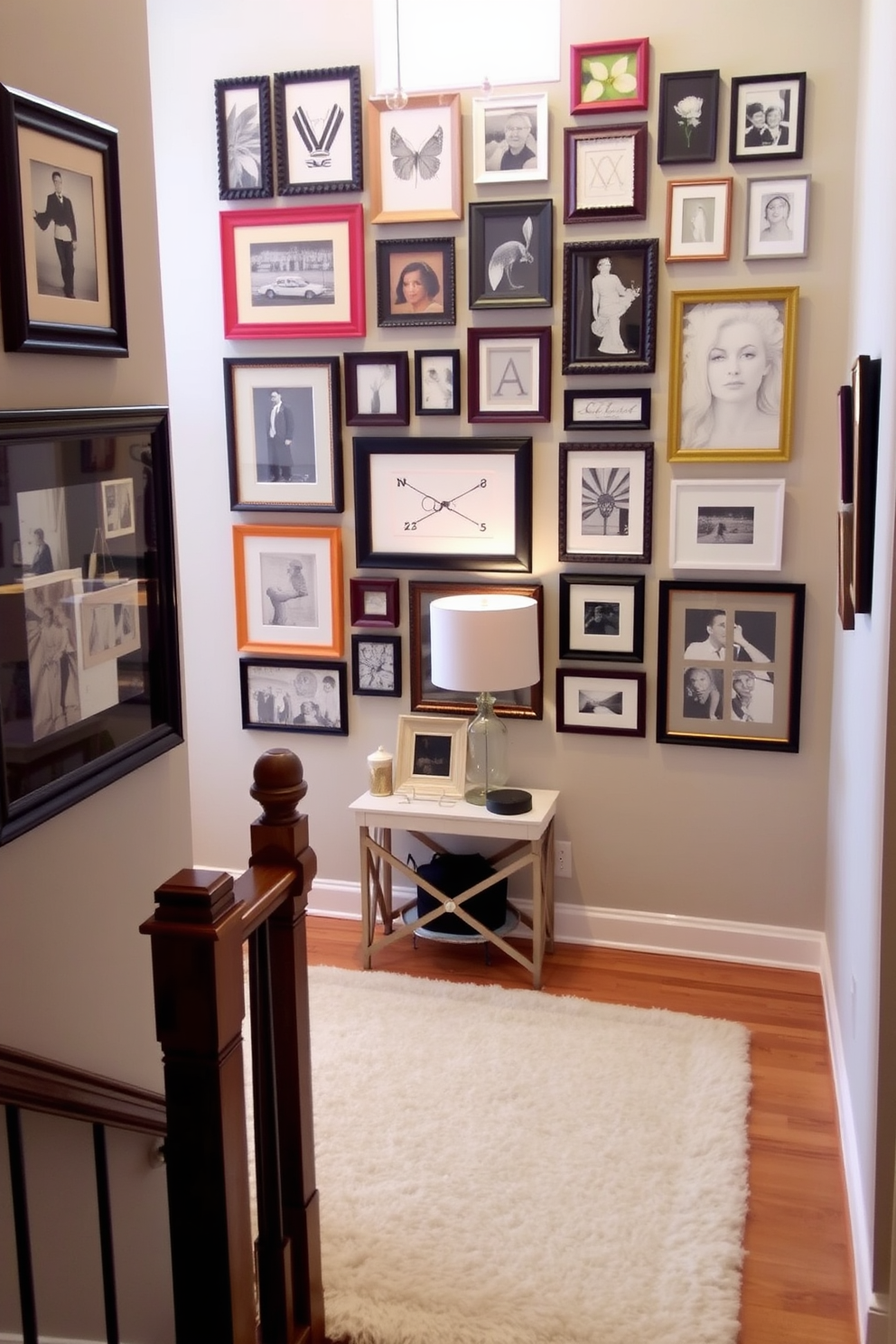 A creative art display featuring an eclectic mix of framed artwork in various sizes and styles. The arrangement is visually striking, with some frames in bold colors and others in classic black and white, creating a dynamic focal point on the wall. The staircase landing is designed with a warm and inviting atmosphere. A plush area rug anchors the space, complemented by a small console table adorned with decorative objects and a stylish lamp.