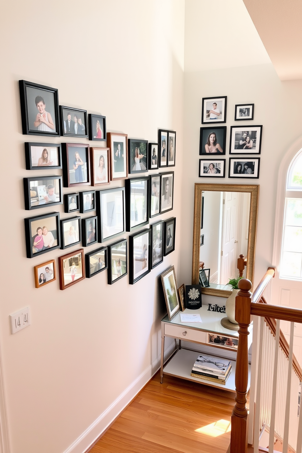 A gallery wall filled with framed family photos in various sizes creates a personal and inviting atmosphere. The wall is painted in a soft white to enhance the vibrant colors of the photographs. The staircase landing features a stylish console table adorned with decorative items and a large mirror above it. Natural light floods the space through a nearby window, highlighting the warm wood tones of the staircase.