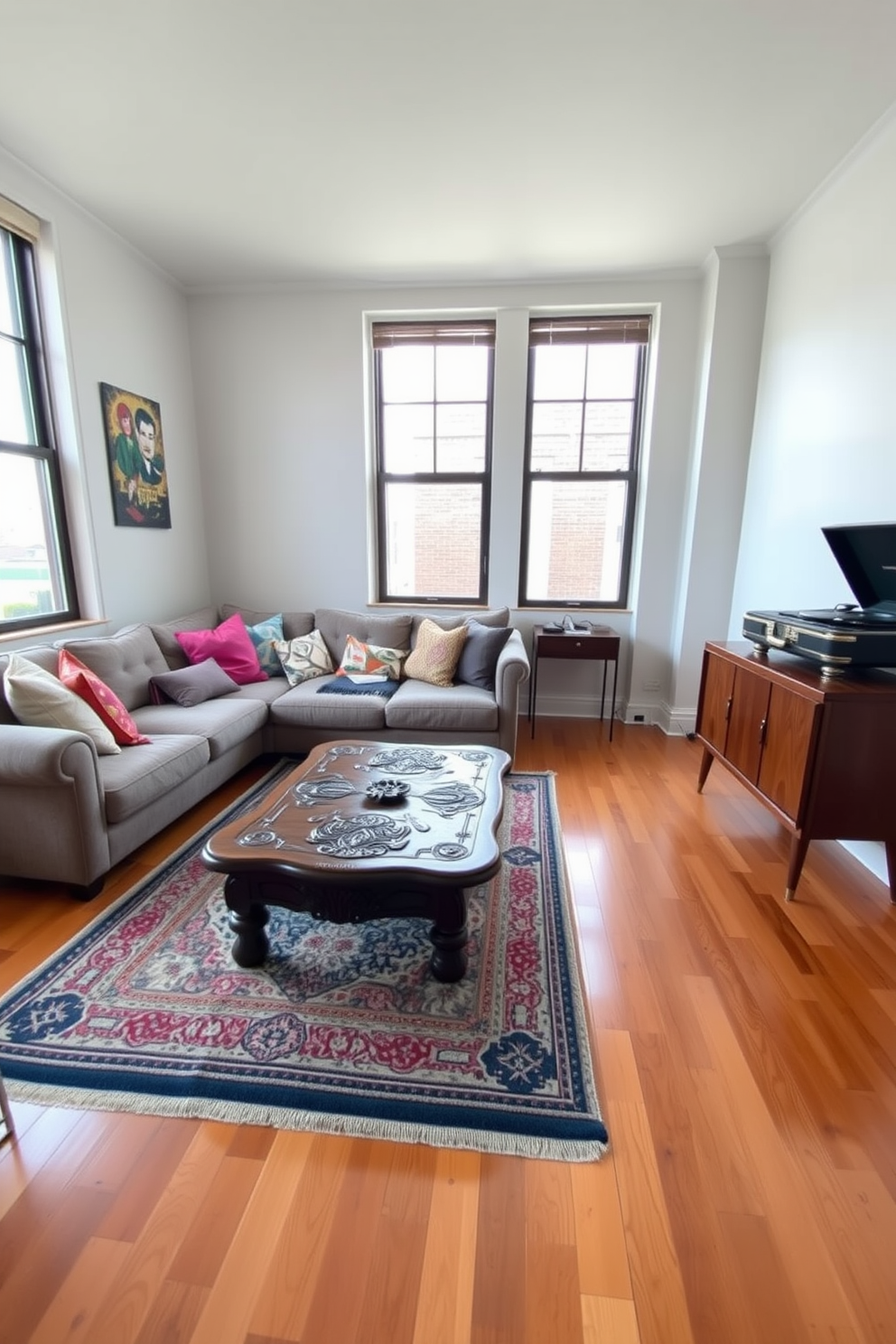 A stylish studio living room featuring a cozy seating area with a plush sofa and a chic pouf for extra seating. The walls are painted in a soft gray, and the floor is adorned with a warm wooden finish, complemented by a large area rug in neutral tones.