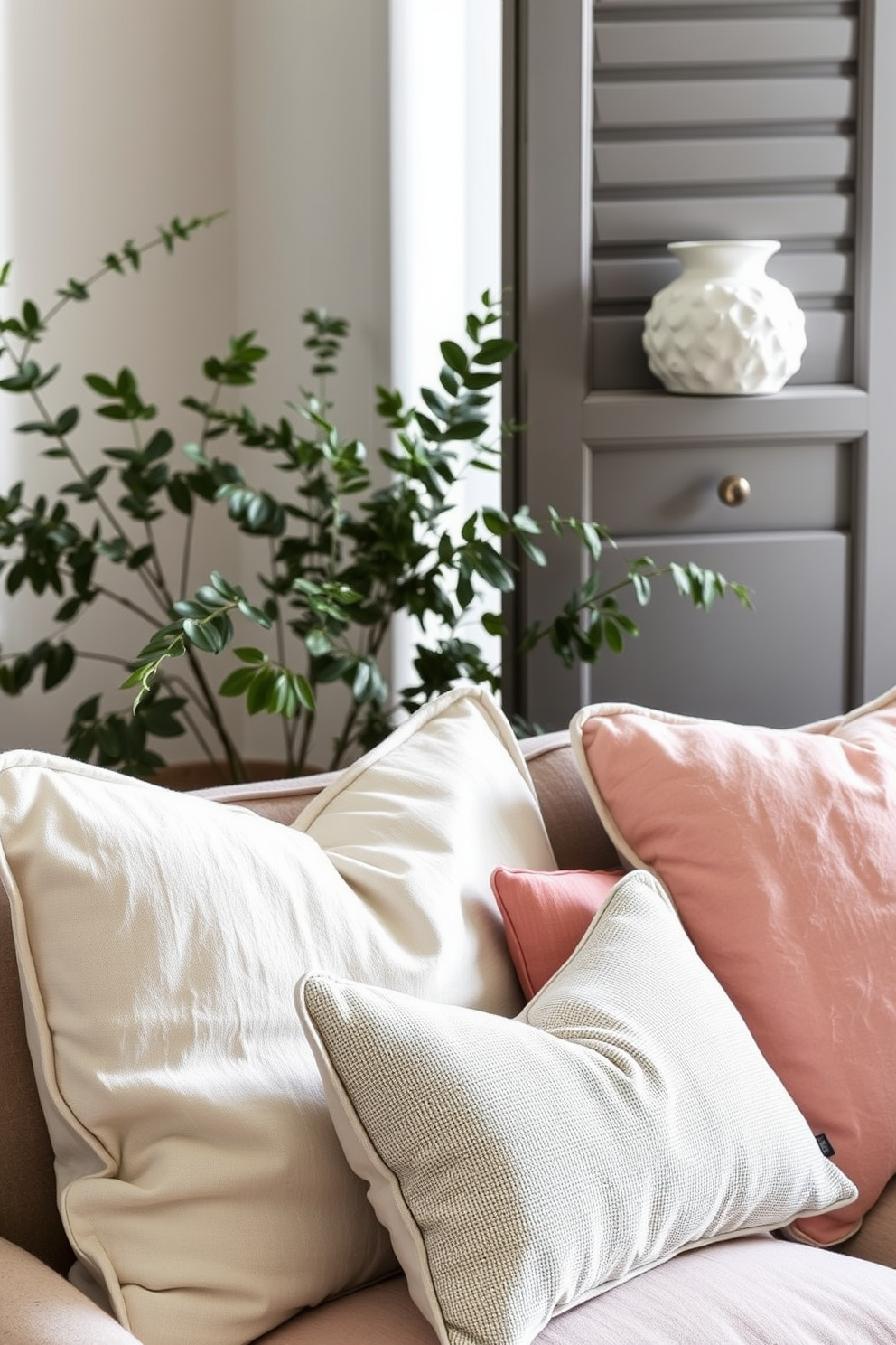 Layered textures in cushions for interest in a summer apartment. Incorporate a mix of linen, cotton, and velvet fabrics in soft pastel colors to create a cozy and inviting atmosphere.